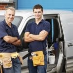 Business Insurance When You Have To Travel 3 Workers In Family Business Standing Next To Van